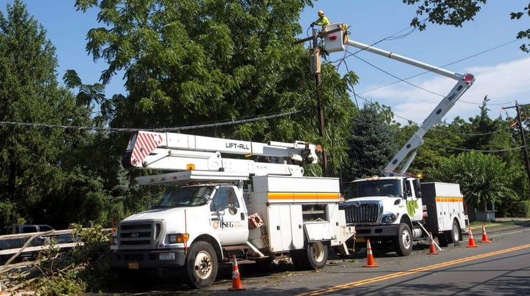 PSEG Long Island crew work on a utility pole on...