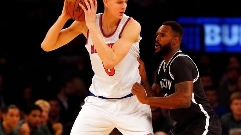 Kristaps Porzingis of the New York Knicks controls the ball...