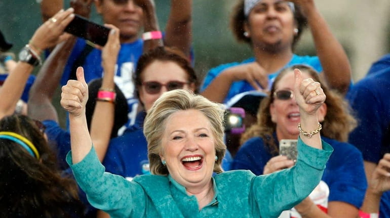 Democratic presidential candidate Hillary Clinton gives supporters a thumbs up...