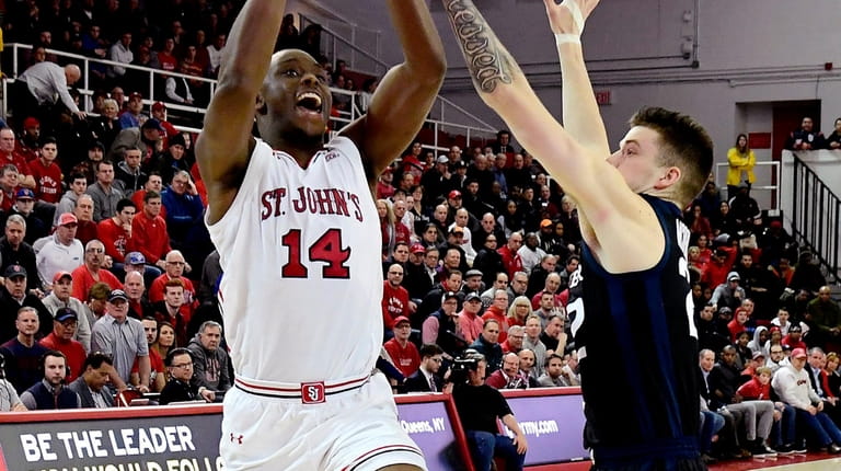 Mustapha Heron #14 of the St. John's Red Storm drives...