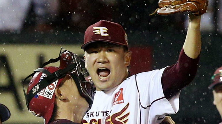 Rakuten Eagles pitcher Masahiro Tanaka, right, celebrates with catcher Motohiro...
