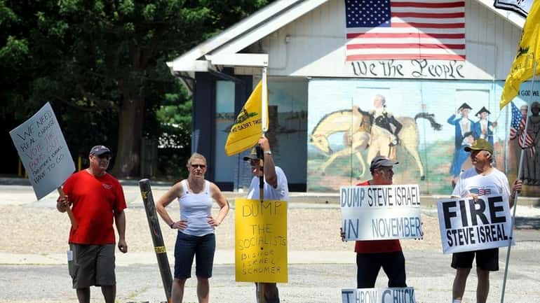 Tea Party members demonstrate against incumbents at the intersection of...