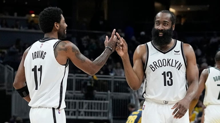 Brooklyn Nets' Kyrie Irving (11) and James Harden (13) celebrate...