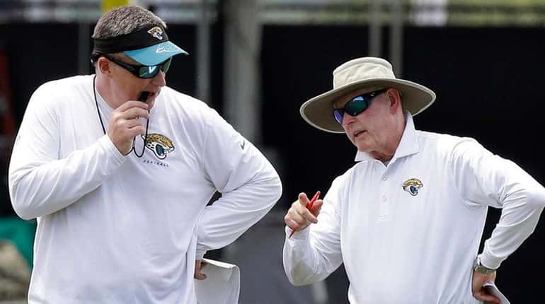 Jacksonville Jaguars head coach Doug Marrone, left, talks with Tom...