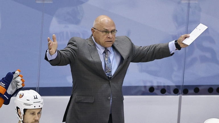 Barry Trotz of the New York Islanders argues a first...