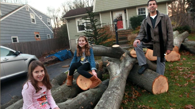 Bruce Segal and his daughters Sophia, 7, left,and and Julia,...