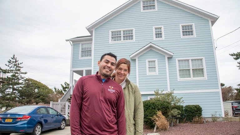 Emmanuel Ponce and Carolyn Mellen in front of the home of...
