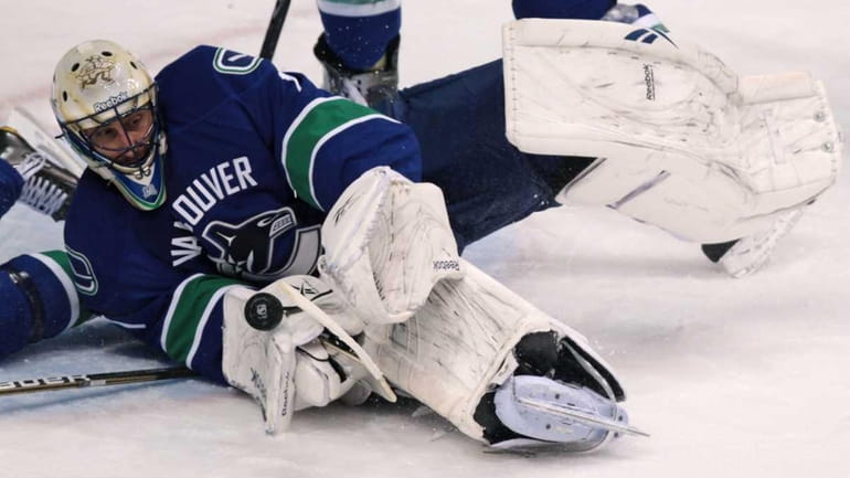 Vancouver Canucks' Roberto Luongo makes a save against the Minnesota...