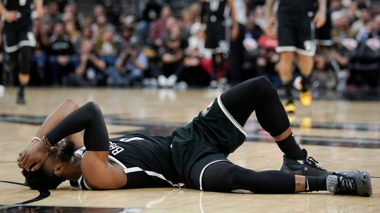 Brooklyn Nets' David Nwaba lies injured on the court during...