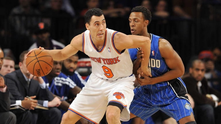 Pablo Prigioni is closely guarded by the Orlando Magic's Ish...