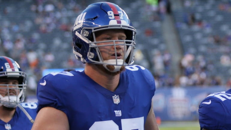 Giants defensive end Josh Mauro takes the field in the...