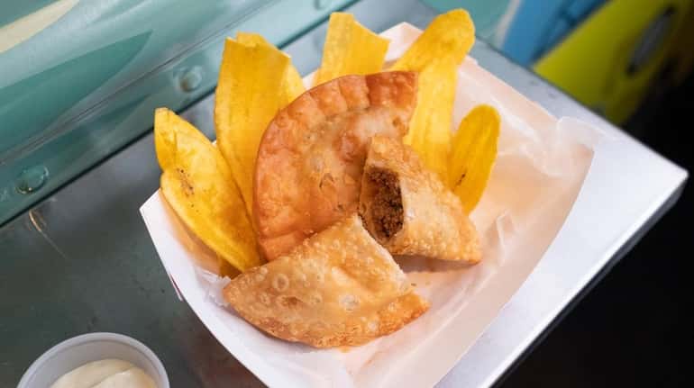 Beef empanadas served with crispy fried plantains at Mama's Cuban...