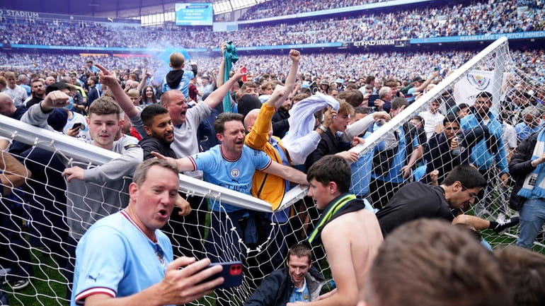 Manchester City fans celebrate after the English Premier League soccer...