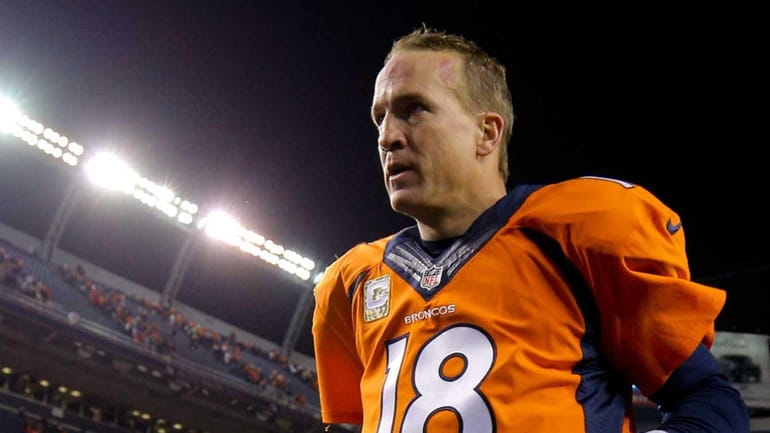 Denver Broncos quarterback Peyton Manning runs off the field after...