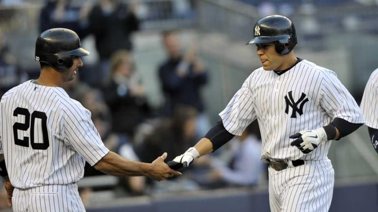 Jorge Posada greets Russell Martin after he hit a home...