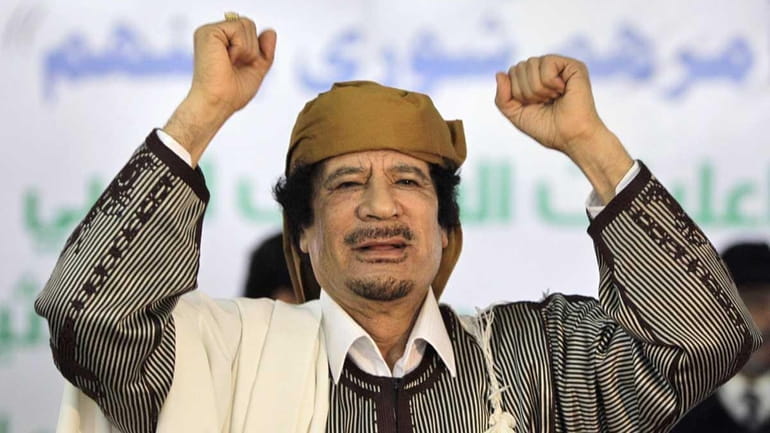 Libyan Leader Moammar Gadhafi gestures to supporters as he arrives...