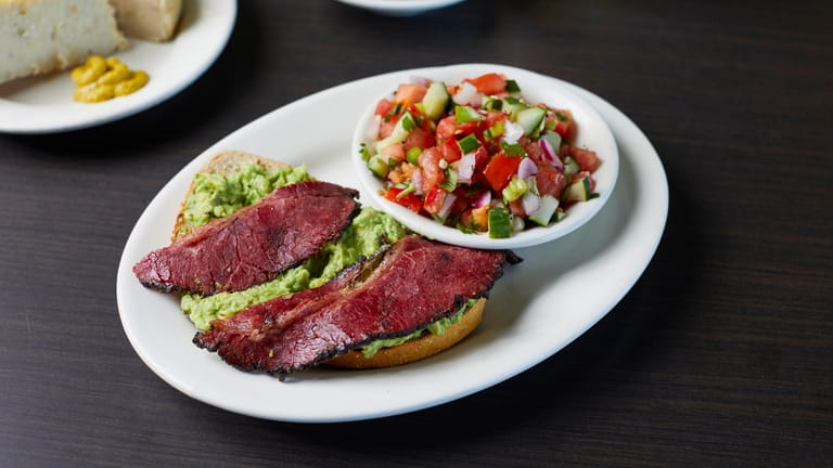 Avocado toast with pastrami and salad at Ben's Kosher Deli...