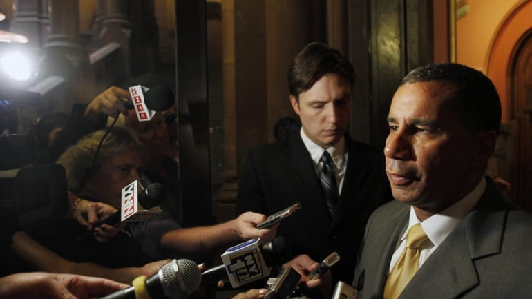 New York Gov. David Paterson talks to reporters about the...