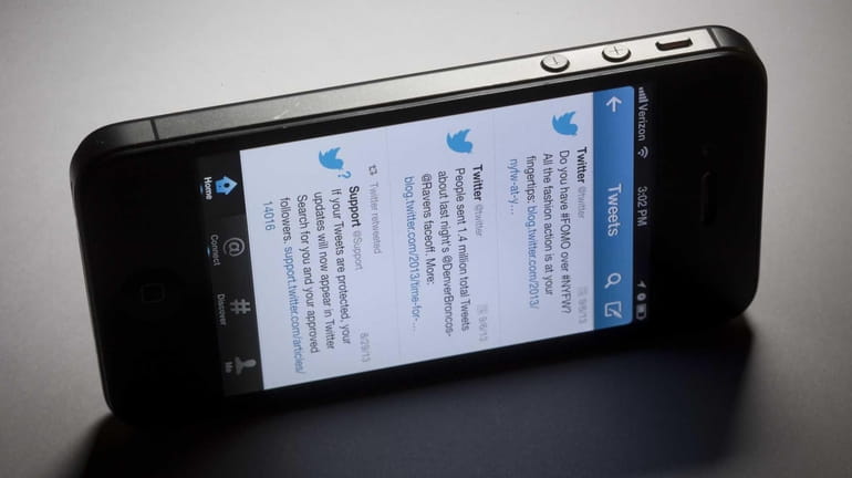 Twitter Inc. tweets show on a mobile device this past...