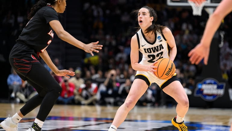 Iowa guard Caitlin Clark (22) steps back before shooting a...