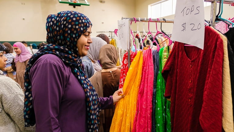 Sania Daniyal, 16, shops for hijabs during the Eid Bazaar at...
