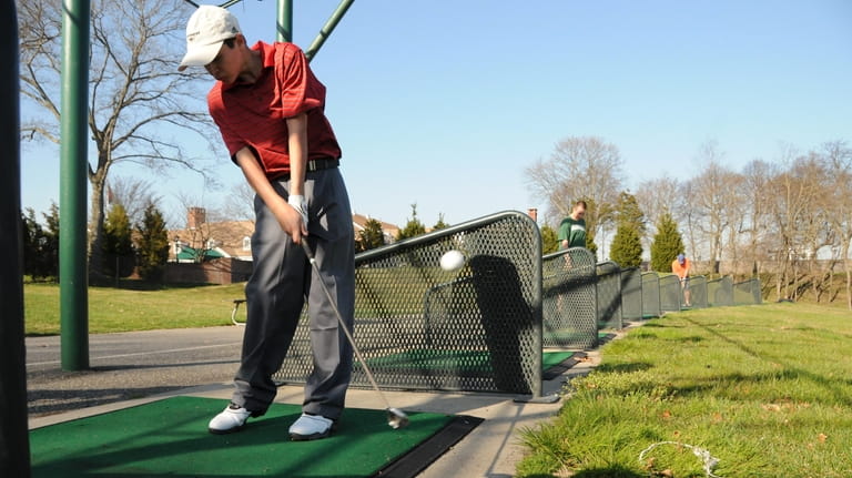 James Schlesinger, 14, of Syosset, practices his swing at the...