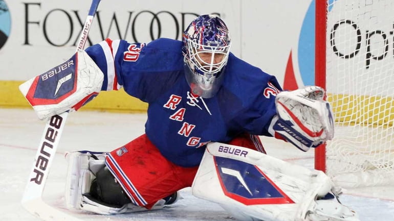 Henrik Lundqvist of the New York Rangers makes a save...