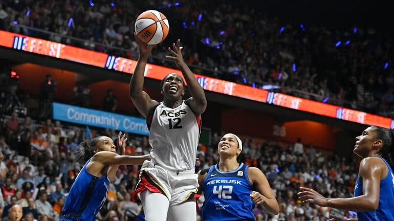 Las Vegas Aces' Chelsea Gray (12) goes up for a...