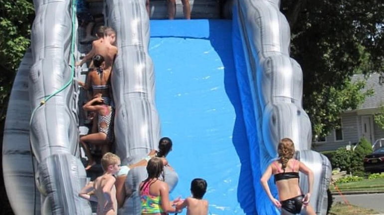 A waterslide at a Wantagh block party.
