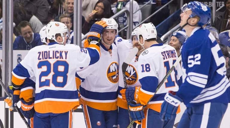 New York Islanders' Brock Nelson, second from left, celebrates with...