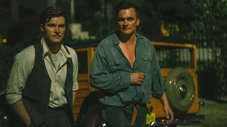 Jack Reynor, left, and Rupert Friend play neighbors who launch...