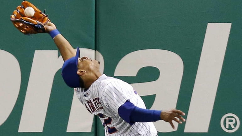 New York Mets centerfielder Juan Lagares makes a seventh-inning, over-the-shoulder...