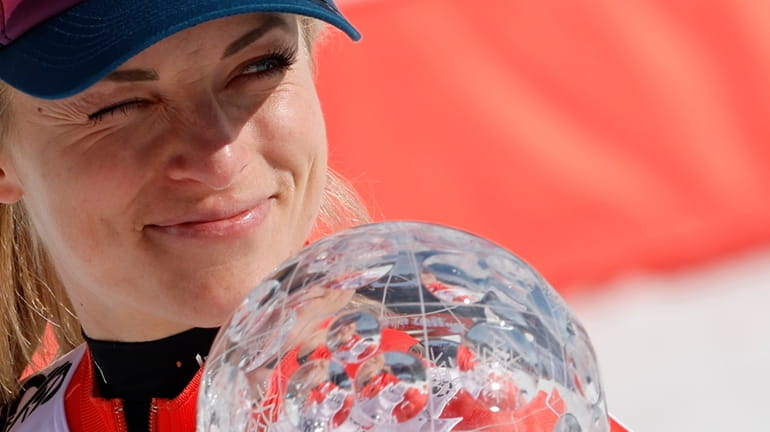 Switzerland's Lara Gut Behrami holds the trophy for the alpine...