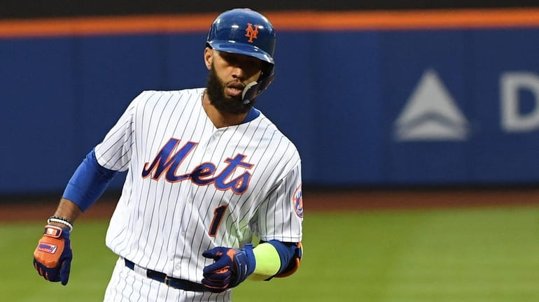 Mets shortstop Amed Rosario rounds third base on his grand...
