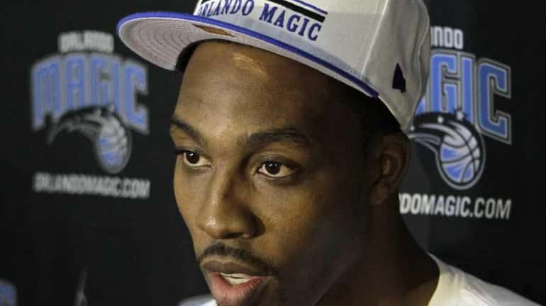 Orlando Magic's Dwight Howard speaks with reporters at training camp....