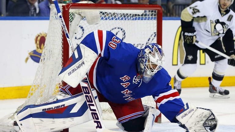 Henrik Lundqvist makes a second-period save against the Pittsburgh Penguins...