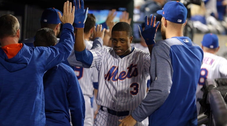 New York Mets centerfielder Curtis Granderson celebrates with teammates after...