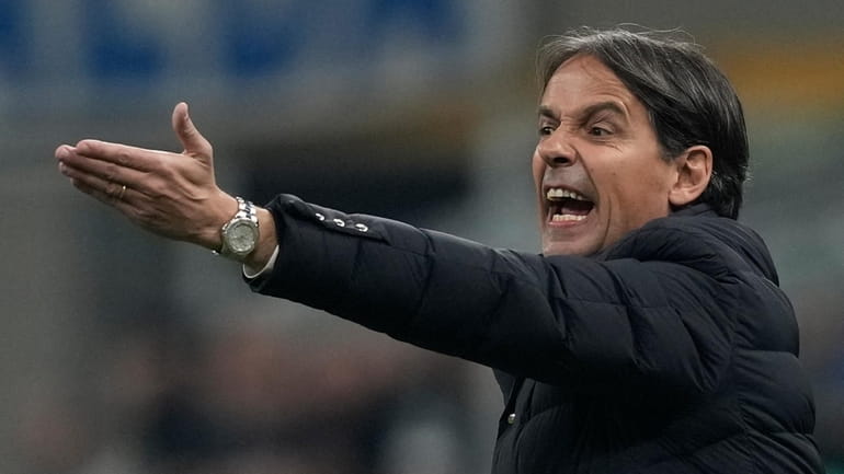 Inter Milan's head coach Simone Inzaghi calls out to his...