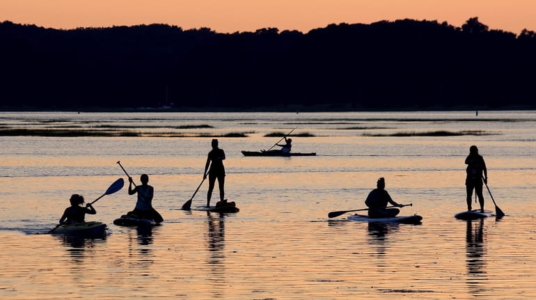 Kayakers and paddle boarders in the Stony Brook Harbor on Wednesday. Water quality...
