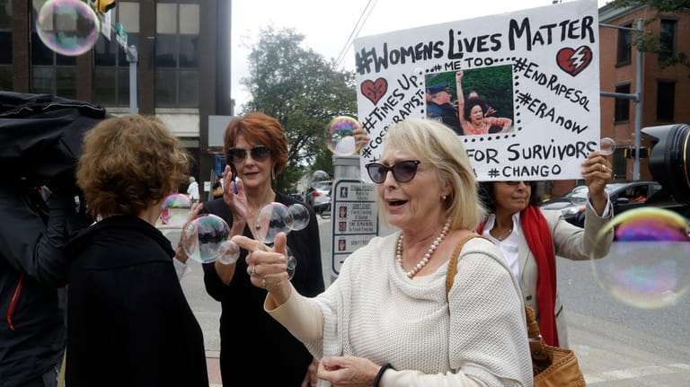 Victoria Valentino, center, appears with a protester near the Montgomery...