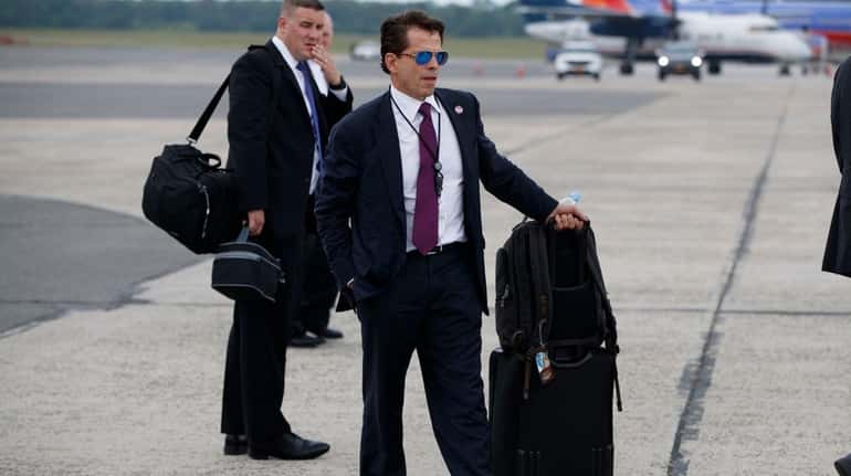 White House communications director Anthony Scaramucci stands on the tarmac...