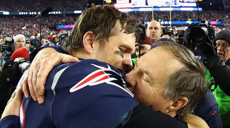 Patriots quarterback Tom Brady celebrates with head coach Bill Belichick...