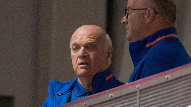 Islanders general manager Lou Lamoriello watching team on the ice...
