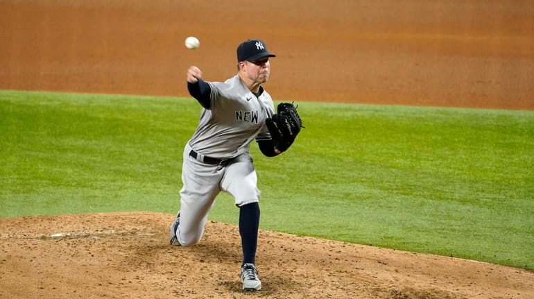 New York Yankees starting pitcher Corey Kluber throws to a...