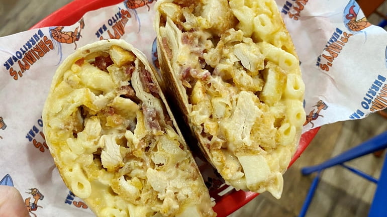 The "Legend" burrito is packed with macaroni and cheese, bacon,...