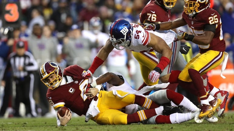 Kirk Cousins of the Redskins is sacked by Olivier Vernon...