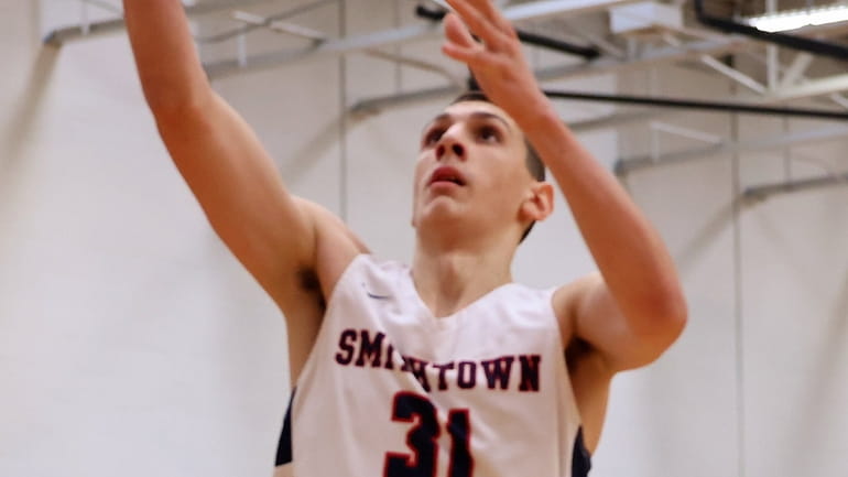 Smithtown West forward Patrick Burke drives the lane with the...