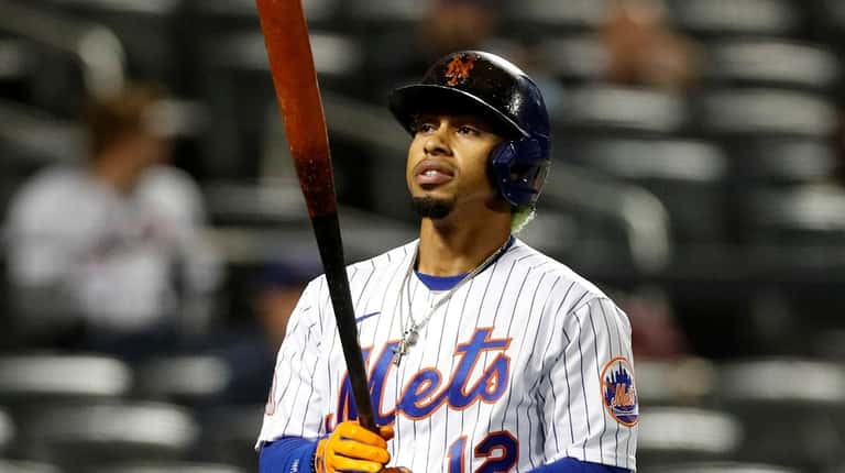 Francisco Lindor #12 of the Mets strikes out during the seventh...