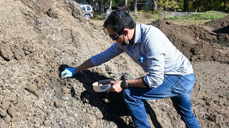 Nick Romero, of the Department of Conservation, removes illegally dumped...
