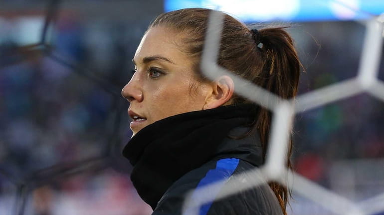 Hope Solo #1 of United States of America gets into...
